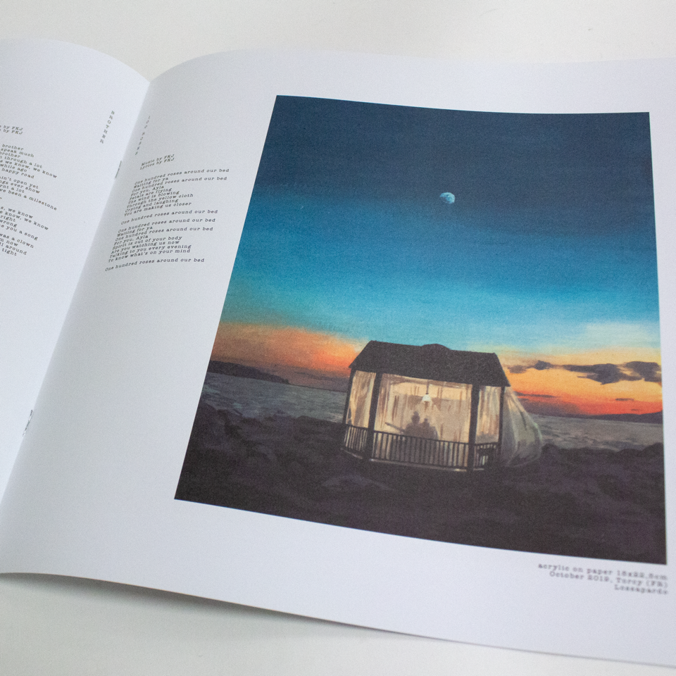 Open book with a scenic illustration of a house on a hill at sunset.